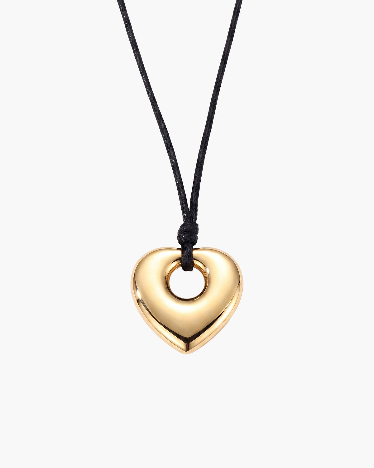 Amara Necklace, polished gold-tone puffed heart pendant with open center on black waxed cord, on white