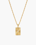 Celeste Necklace, rectangular gold-tone pendant with sunburst ridges and a central clear stone