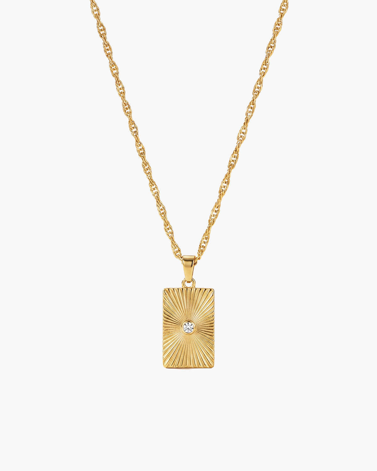 Celeste Necklace, rectangular gold-tone pendant with sunburst ridges and a central clear stone