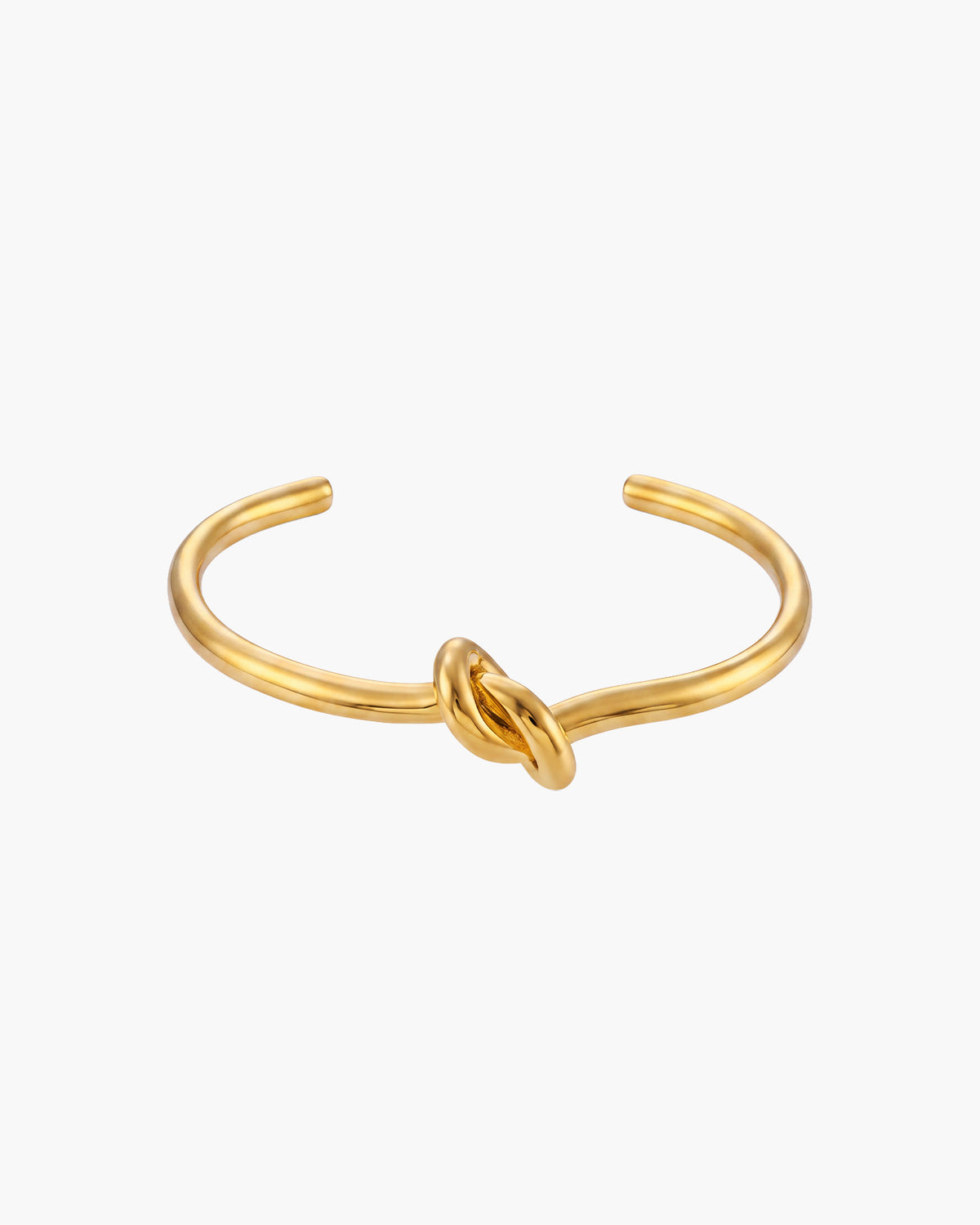 Nudo Bangle, open gold-tone cuff with a polished knot at the center, front view on white