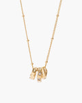 Vera Necklace, three gold-tone charm rings, one hammered and one set with clear stones, on a beaded chain